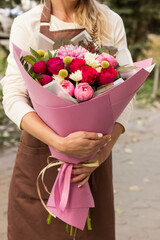 girl florist holding a bouquet close-up