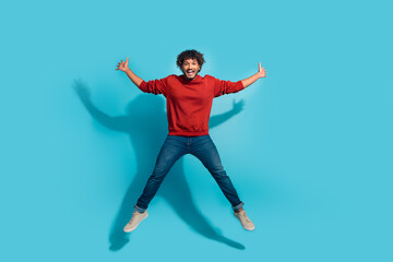 Fototapeta na wymiar Full body size photo of overjoyed energetic mexican man jumping raised arms up in star shape isolated on aquamarine color background