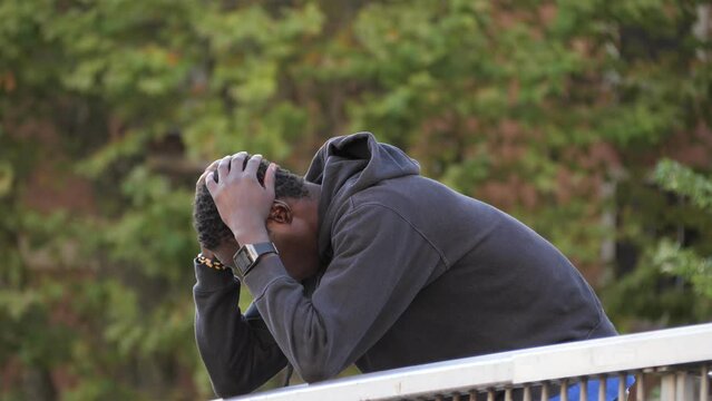 Young Black Man on Bridge: Struggle with Depression and Immigrant Exclusion