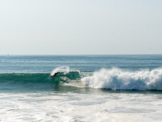 A man surfs a wave, ocean, barrel, sports. High quality photo