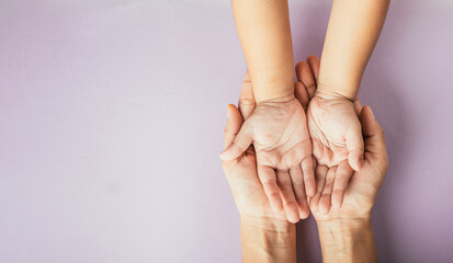 Family day concept, Parents and kid holding empty hands together on a color background. Celebrating...