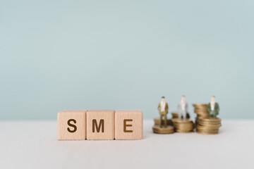 SME Startup Idea ,wooden cube blocks with SME abbreviations of Small and Medium Enterprises with...