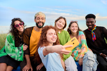 Multi-ethnic group smiling generation z boys and girls taking selfie outdoors. Happy lifestyle...