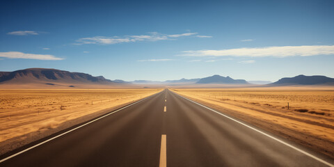 Endless desert road with distant mountains under clear skies