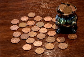 Old Silver Pot and Copper Coins on a Polished Wooden Surface - 747930948
