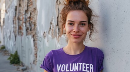 Naklejka na ściany i meble Young woman with a radiant smile wearing a purple t-shirt with the word 