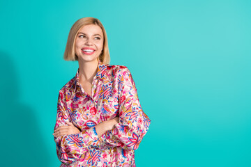 Photo of dreamy woman with bob hair dressed print blouse keep palms folded look at discount empty space isolated on teal color background