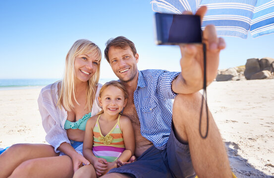 Happy family, beach and relax with selfie for picture, moment or photography in outdoor nature. Mother, father and child with smile for photo, camera or bonding memory together on the ocean coast