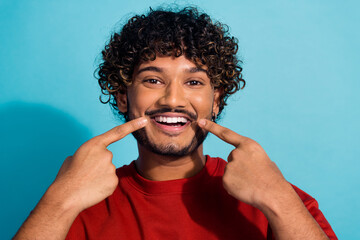 Closeup photo of young mexican man fingers point white teeth caries restoration hygiene cavity isolated on aquamarine color background