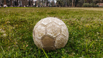 old soccer ball, old football on grass, white football on grass 