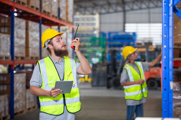 Male professional walkie talkie control worker in warehouse. Supervisor import-export shipping transportation, logistic business factory concept.