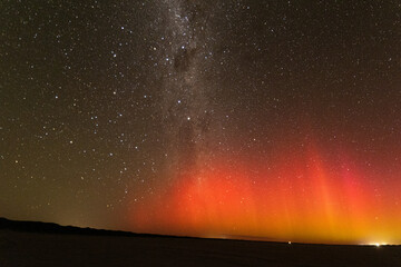 Bright red burst of Aurora Australis and milky way, Southern Australia