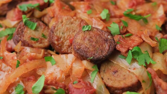 Stew cabbage with a sausage and bacon. Rotating video
