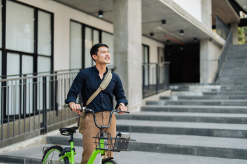 Fototapeta na wymiar Young businessman in suit in city bike to work eco friendly alternative vehicle green energy