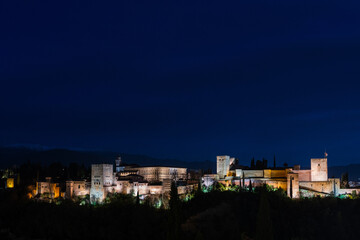 Panorama view of the Alhambra in Granada on a clear Spring night, a palace and fortress complex that remains one of the most famous monuments of Islamic architecture. - 747970761