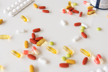 Medicine pills, drugs in different colours arranged on a white background. Health care medical concept.