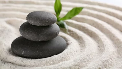   Zen garden stones on white sand with pattern © wiizii