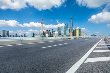 Asphalt highway road and city skyline with modern buildings in Shanghai