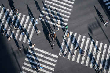 Pedestrians crossing the street at a busy intersection in Ginza, a popular upscale shopping area of Tokyo, Japan. - 747989531