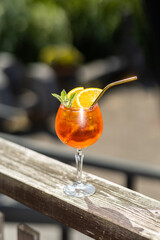 glass of aperol spritz cocktail in sunny day