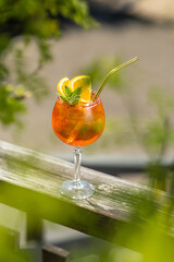 glass of aperol spritz cocktail in sunny day
