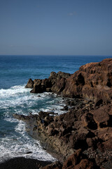 Fototapeta na wymiar Sea and rocks. Cliffs in El Golfo, a coastal village on the island of Lanzarote (Spain).