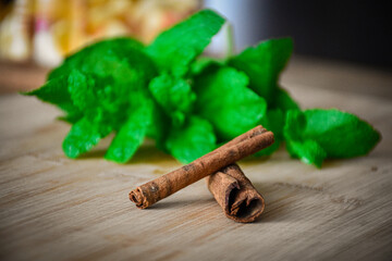 Mint with cinnamon on a wooden table