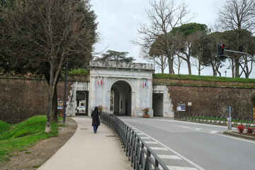 Fototapeta na wymiar Lucca, Italy: Enter part of the medieval city wall across the road 