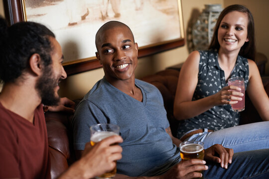 Friends, beer and drinks at pub, smile and relax indoor for glass and bonding in summer to diverse. Male people, bar and chill for social, guys and alcohol together and laughing for fun and weekend.