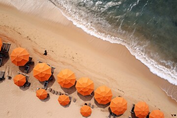 an aerial view of an orange umbrellas on a beach