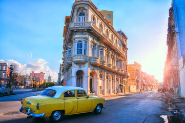Fototapeta na wymiar Yellow retro car on the ancient streets of Havana. Cuba. Coloring cubes. Vintage retro car