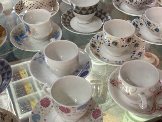 Assorted porcelain teacups and saucers with various patterns