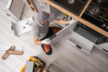 Kitchen Cabinetmaker Installing Furniture Inside a Apartment - 748004963