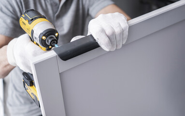 Professional Caucasian Cabinetmaker Contractor with a Drill Driver - 748004966