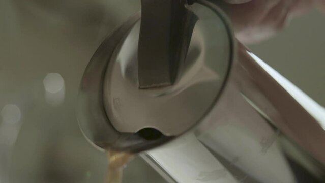slow motion pouring into cup from coffee brewer 