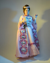 cinematic  portrait of female model wearing an opulent pink gown,  costume of a historical French baroque nobility, style of Marie Antoinette. Holding ring of keys,  Isolated on  studio background