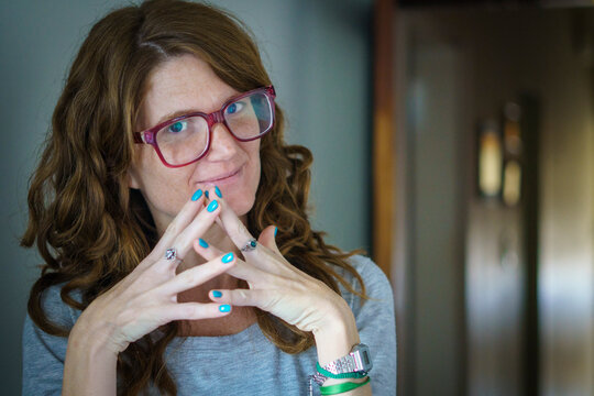 Indoors Portrait Of A Woman Showing Her Painted Nails