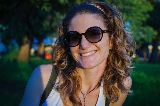 Portrait of a smiling young woman in sunglasses