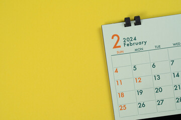 close up of calendar on the yellow table background, planning for business meeting or travel planning concept