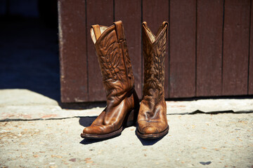 Cowboy boots, ranch and style at farm for walking, safety and retro fashion on floor, ground and...