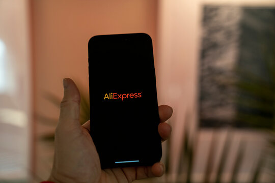 Aliexpress application icon on smartphone screen. Person holding Apple Iphone 14 Pro Max phone. A popular e-commerce application. Budapest, Hungary. November 2023.