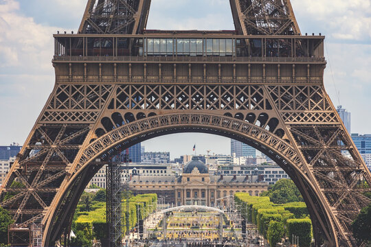 Eiffel Tower. Close-up view of the arch of the1st level. Champ de Mars and Ecole Militaire in perspectives. Paris, France