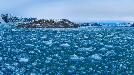 Iceberg, Blue Ice floes, Drift floating Ice, Snowcapped Mountains, Albert I Land, Arctic,...