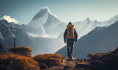 Cercles muraux Everest Male hiker traveling, walking alone in Himalayas under sunset light, man traveler enjoys with backpack hiking in mountains. Travel, adventure, relax, recharge concept.