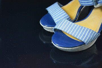 Stylish and unusual women's shoes made of blue genuine patent leather and blue fabric. Sandals,...