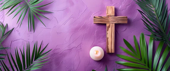 Fotobehang Wooden cross with a burning candle on a purple background with palm leaves. © mandu77