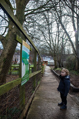 A child visiting the farm reading a sign.