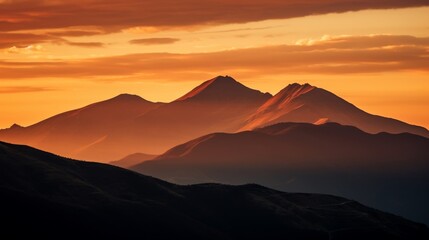 Fiery sunset over a silhouetted mountain ridge