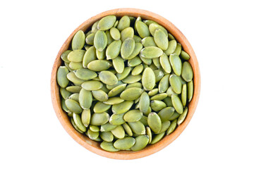 Peeled pumpkin seeds in a wooden bowl concept background
