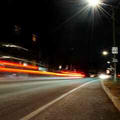 Car motion trails. Fast moving light effect, long exposure street night time photography in downtown area